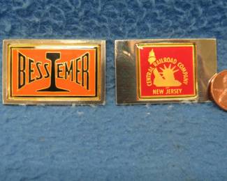 Lot 317. Two sterling silver ingots from "The Great American Railroad Emblems" series. The New Jersey Central and the Bessemer and Lake Erie. Total weight 47.51 grams.