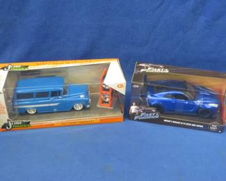 Lot 325. Two die-cast cars: Jada 1957 Chevy Suburban. Fast & Furious Brian's Nissan GT-R Ben Sopra. Both appear to be new in the box.