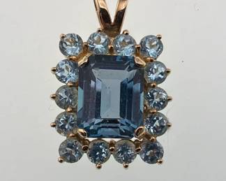 14kt London blue topaz pendant surrounded by blue topaz