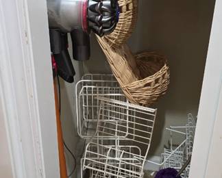 This closet is through the kitchen on your way to the garage.  There is a handheld Dyson vacuum for sale!