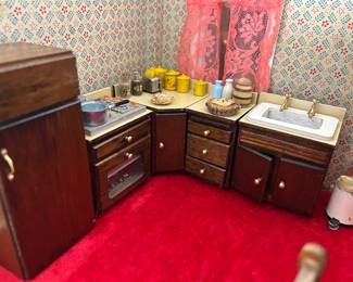 Dollhouse kitchen complete with foods, ice cube trays, pots, pans, coke crate and sodas, tomatoes and vegies in fridge, the details cannot be overstated. 