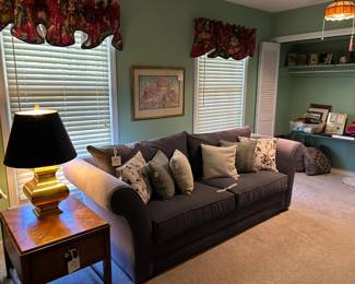 sofa, pillows, brass lamp, end table