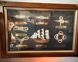 Vintage Nautical Knots Display with Ship Model and Lifebuoy