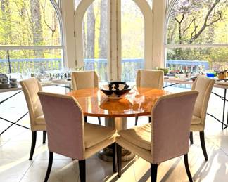Dining Table with a stainless steel column. Table top has a sunburst veneer in a Madagascar Rosewood with a high gloss finish. Set of 6 Art Deco Chairs, upholstered in an off-white crewel-patterned fabric with lilac ultra-suede