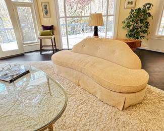 PAIR of curved armless sofas upholstered in a bone colored silk and cotton chenille. 7'6" L x 39" D x 35" H