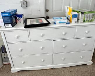 White Drawer Dresser with Framed Art and Assorted Boxes