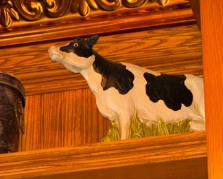 Black and White Holstein Cow Figurine on Wooden Shelf