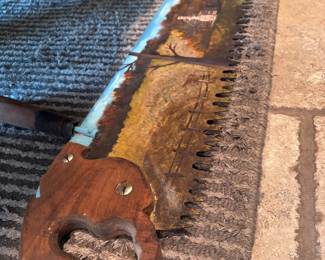 Vintage saw with painted scene on blade 