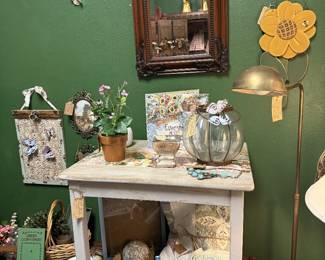 white side table, floral lamp, books, tea pot, framed art