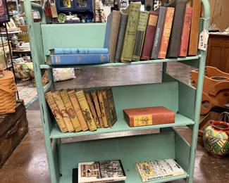 Vintage mint green industrial library metal trolley cart and vintage books 
