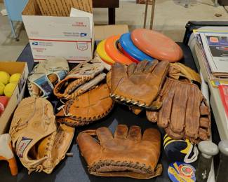 Vintage baseball gloves, and frisbees