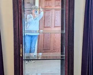 Howard Miller Mahogany Lighted Curio Cabinet with Four Glass Shelves.