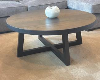  Arhaus “Acero” coffee table 42" dia. - Artisan-finished metal top and alder wood base.