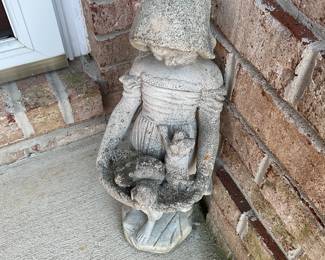 Little girl with kitten outdoor stayue