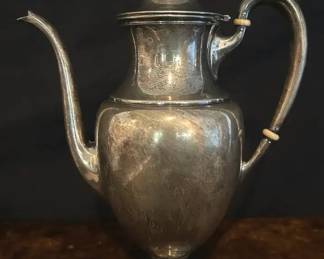 Antique Sterling Silver Teapot w/ Bakelite Accents – Footed (#65) Elegant antique sterling silver teapot featuring a classic urn form with pedestal base, hinged lid, and curved spout. Accented with Bakelite handle insulators for heat protection.  Condition: Shows tarnish and surface wear consistent with age; Bakelite spacers intact; no major dents noted (see photos).  Measurements: Approx. 9–10” H  Stamped “Sterling” with #65 approximate weight is 1lb 3.1 ounces Bakelite handle accents Hinged lid with finial .  To BID on this item please go to Dothan CTBids  This ONLINE Estate Sale begins closing on Thursday, 4/30 @ 5:30!!  Don't forget to place your MAX PROXY BID & Let the CTBids System BID 4 YOU! PU is in Dothan!  Specific address will be provided to winning bidders on their invoices!! Sale ends 4/30 start'g @ 5:30 – Pick-up will be on SATURDAY 5/2....  Shipping is available on certain items at Buyers Cost.