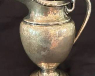 Antique Sterling Silver Cream Pitcher – Footed (#65) Classic antique sterling silver cream pitcher with elegant curved spout, handle, and pedestal base. Simple, timeless form with nice weight and presence.  Condition: Shows tarnish and surface wear consistent with age; no major dents noted (see photos).  Measurements: Approx. 5” H  Stamped “Sterling” with #65 Solid sterling silver - approximate weight is 6.0 ounces Classic footed form with handle.  To BID on this item please go to Dothan CTBids  This ONLINE Estate Sale begins closing on Thursday, 4/30 @ 5:30!!  Don't forget to place your MAX PROXY BID & Let the CTBids System BID 4 YOU! PU is in Dothan!  Specific address will be provided to winning bidders on their invoices!! Sale ends 4/30 start'g @ 5:30 – Pick-up will be on SATURDAY 5/2....  Shipping is available on certain items at Buyers Cost.