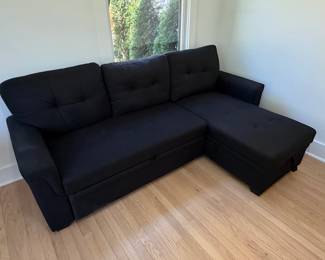 Black Upholstered Sectional Sofa with PullOut Bed and Storage Chaise