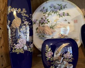 Beautiful blue Asian pieces with a set of Asian design plates behind