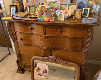 antique dresser with mirror and picture frames