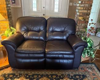 Leather eggplant color double recliner.  Great shape and both recliners work
