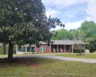 Take a beautiful ride 2 miles from town to find this All brick 2 bdrm, 1.5 bath with bonus room and gorgeous large Sunroom, partial basement, & workshop + 2 car carport priced at just $285,000