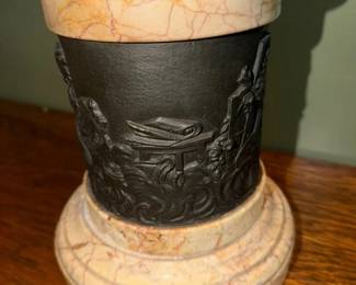 Bronze panels on marble bases. 