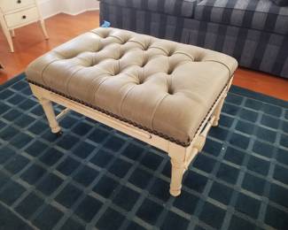 Leather upholstered ottoman; area rug