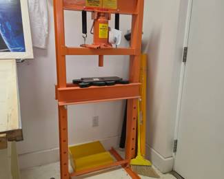 hydraulic shop press, specifically a 20-ton capacity model used for pressing, bending, and straightening metal components. 