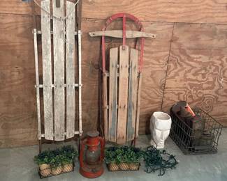 Antique sleds and antique lantern bundle. Beautiful vintage winter décor bundle featuring two classic wooden sleds and rustic accent pieces—perfect for creating that cozy, nostalgic seasonal look.  This set is ideal for porch styling, holiday décor, or farmhouse displays. Everything you need to create a warm, vintage winter vibe in one bundle.