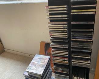 A Tower Of CDs, DVDs And Three Vinyl LPs