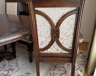 R11 - $750. Michael Amini Signature Series by AICO Hazelnut “Villagio” table & chairs wood dining table set & china cabinet.  Table does have some surface scratches and Table has 6 upholstered chairs and extendable leaf for flexible sizing. Chairs have leaf patterned fabric seats and backs, with carved wood frames.  DIMENSIONS:   Table w/ leaf 84” L x 60” W x 31”H  Leaf 24”W  Arm Chair  Seat 27.25”W x 24.25 D x 45”H  Side Chair Seat 24”W x 24.25 D x 45”H Floor to seat 19”  China Cabinet  Dimensions: 88 1/2"H x 66"W x 19"D Features Built in 3-mood touch lighting system