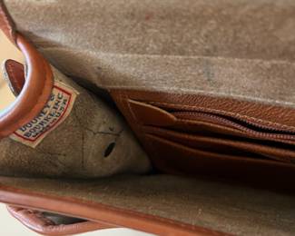 R47 - $20. Vintage Dooney & Bourke Calvary Crossbody. Measures 9" x 9" x 3". Has been used - the white leather needs cleaned. 