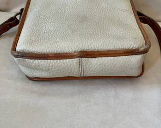 R47 - $20. Vintage Dooney & Bourke Calvary Crossbody. Measures 9" x 9" x 3". Has been used - the white leather needs cleaned. 