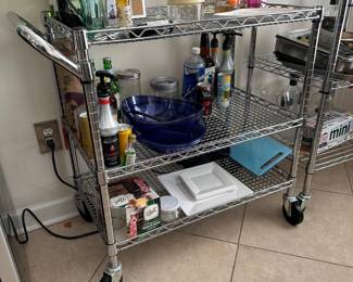 R14 - $30. Stainless 3 Tier Rolling Cart. Measures 35" x 18" x 32" tall. Has been used in the kitchen and needs cleaned. Shelves are adjustable. 