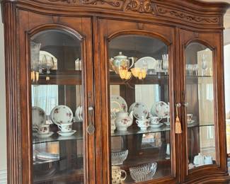 R11 - $750. Michael Amini Signature Series by AICO Hazelnut “Villagio” table & chairs wood dining table set & china cabinet.  Table does have some surface scratches and Table has 6 upholstered chairs and extendable leaf for flexible sizing. \  DIMENSIONS:  China Cabinet  Dimensions: 88 1/2"H x 66"W x 19"D Features Built in 3-mood touch lighting system