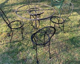 Table and 4 chairs with glass top and cushioned seats. 