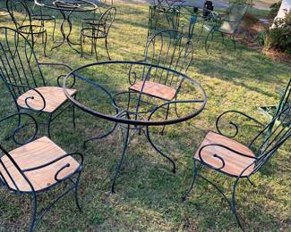 Heavy iron table and chairs with glass top. 