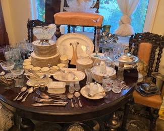 Antique carved wood dining table (5 leaves) with 4 hand carved barley twist chairs; large porcelain dish set; Waterford wine and water glasses; lots of porcelain and silverplate serving pieces