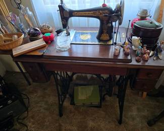Beautiful early Singer electric sewing machine in carved antique cabinet