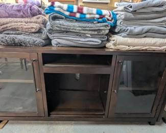 TV entertainment stand cabinet, blankets.