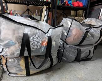 Large bags of women's clothing including jeans, sweats, leggings, shorts, skirts, T-shirts, blouses, dresses, coats, jackets, scarves, gloves, hats, and more.