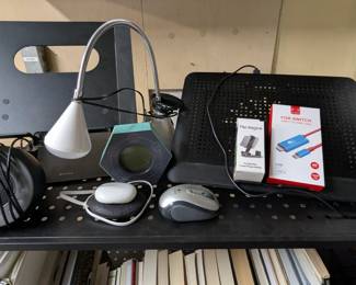 Laptop mount, laptop cooling tray, computer wireless mouse, sound machine, Ottlite lamp, pomodoro timer, meditation guide, Nintendo Switch USB to HDMI cable, phone mount.