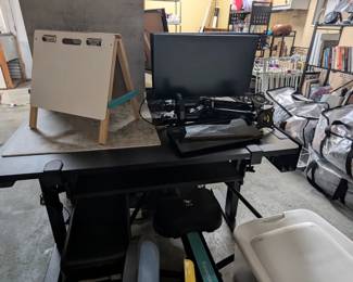 Electric standing desk with attachments, computer monitors, photography backdrop kit, foldable dry erase and chalkboard, and more.