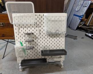 Ikea pegboard with shelves, bins, hooks, and more.