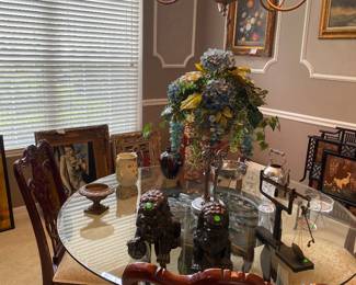 Beautiful chippendale style chairs, detailed pedestal style table and so much art and decor