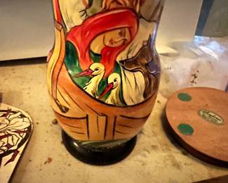 Hand-painted wooden Russian nesting doll with narrative scene.