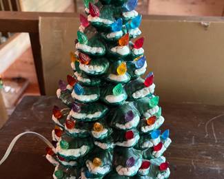 Vintage illuminated ceramic Christmas tree with colorful lights.