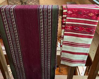 Two hand-woven Andean Aguayo textiles, likely wool, with geometric patterns.