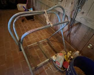 A vintage metal saddle rack for equestrian use.