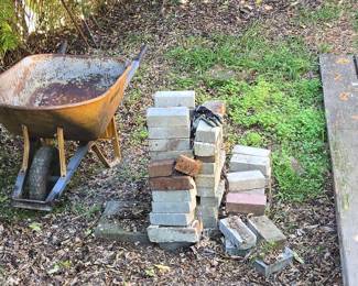 Vintage Metal Wheelbarrow with Stacked Bricks